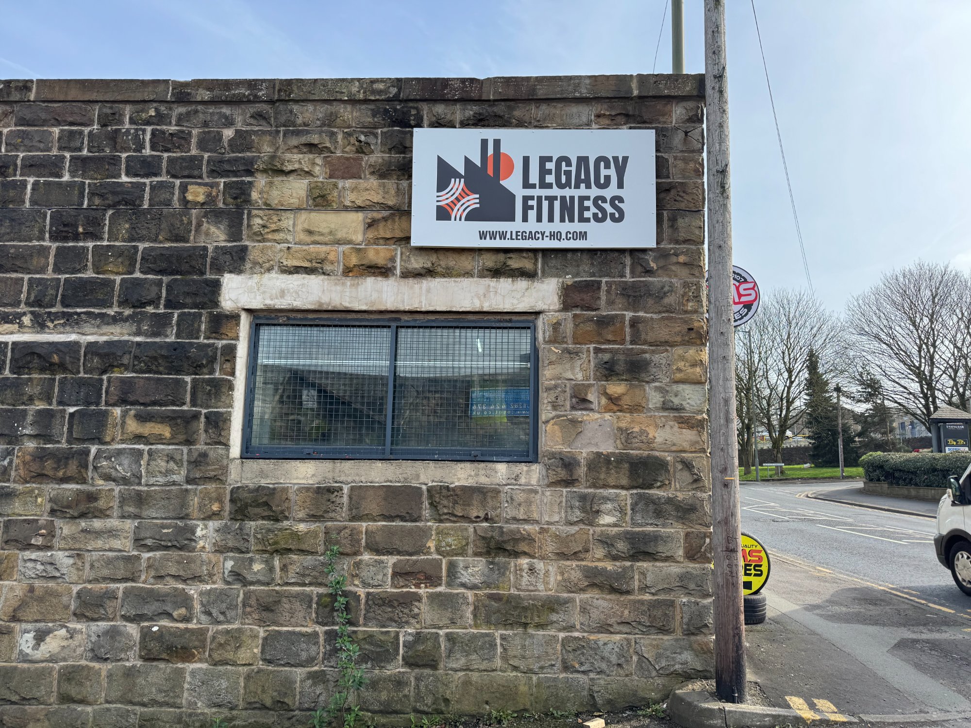 Legacy Fitness sign on stone wall